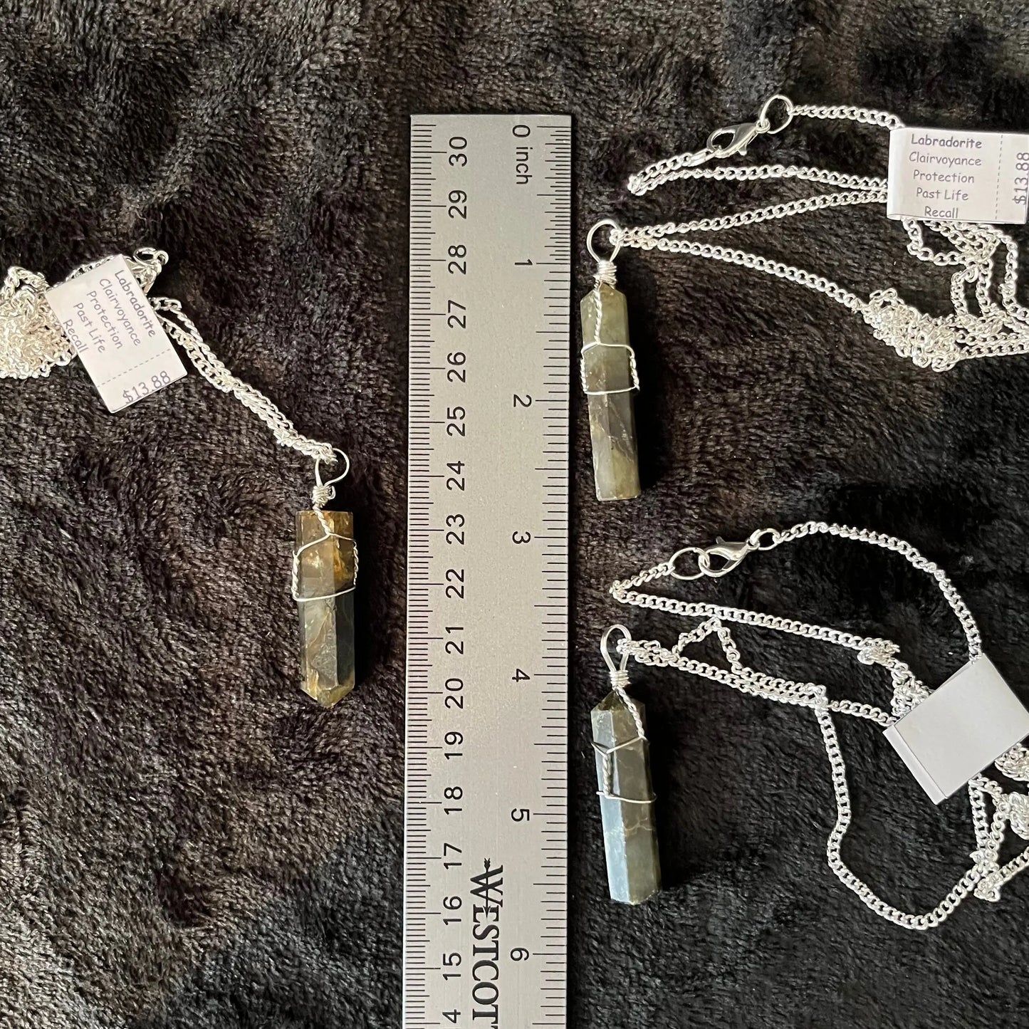 3 Silver Wire Wrapped Labradorite Point Pendants, attatched to silver chains. Stone are approximately 1 1/4" - 1 1/2" long, displayed next to a ruler.