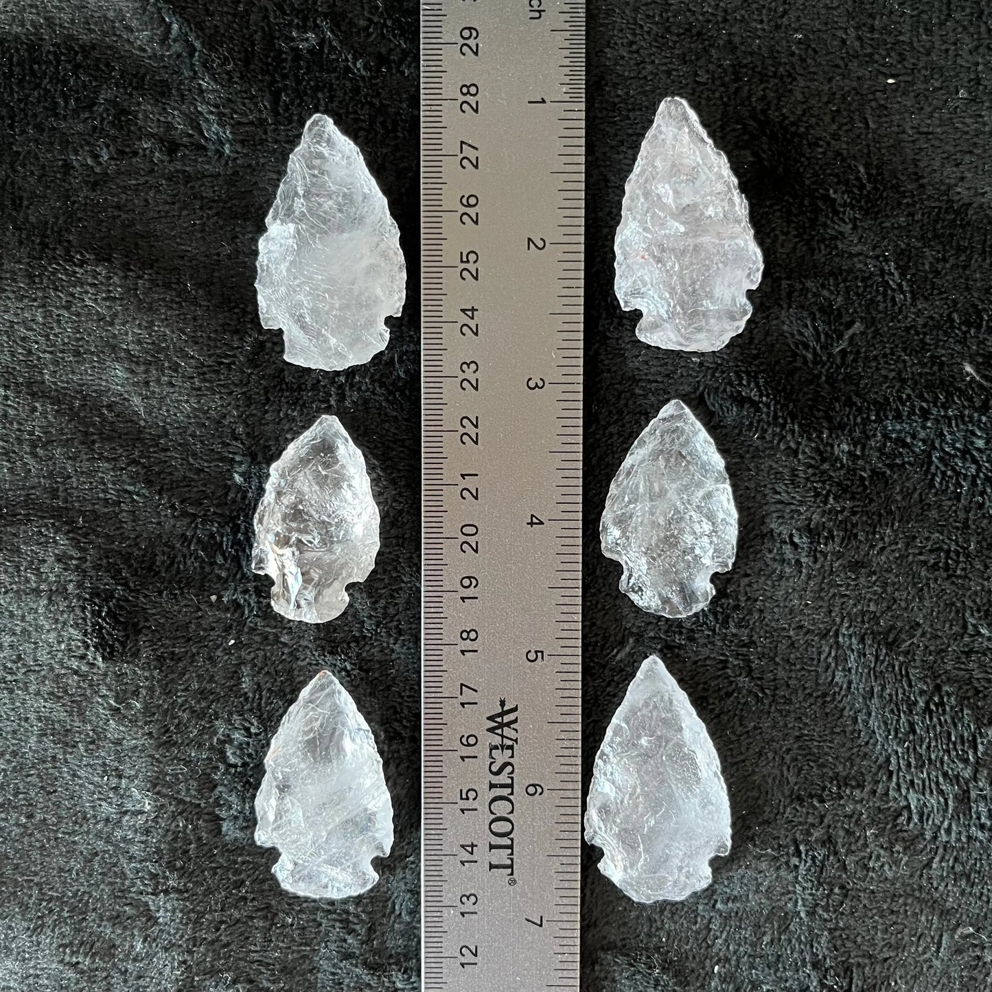 6 beautiful marbled quartz knapped arrowheads displayed next to a ruler. Quartz arrowheads are approximately 1 3/4” long.
