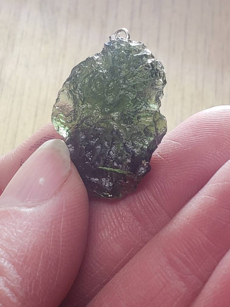 Naturally formed Moldavite from Czech Republic, (4.9 gr) One Crystal, Rough, with .925 silver bell MOL-0016