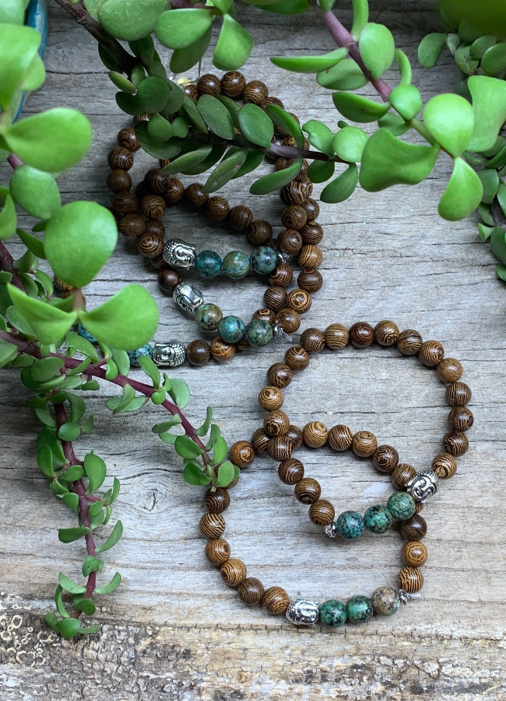 5 bracelets, each made of 8mm wooden beads, 3  african turquoise beads, and  1 budda head bead.