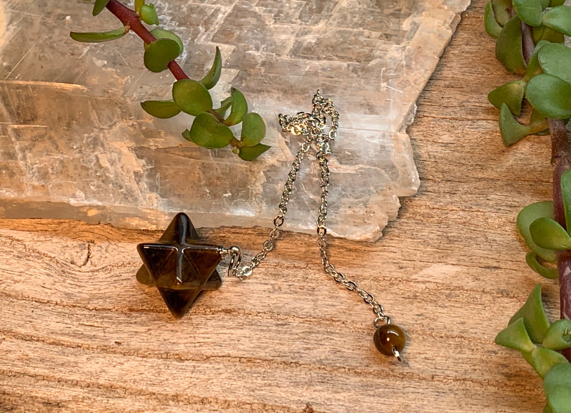 3/4" bronze and brown tiger eye merkaba shaped pendulum on an 8 inch silver chain