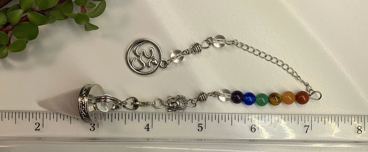 1 inch amethyst pendulum attatched to 8 inch chain including a silver crescent moon displayed next to a ruler