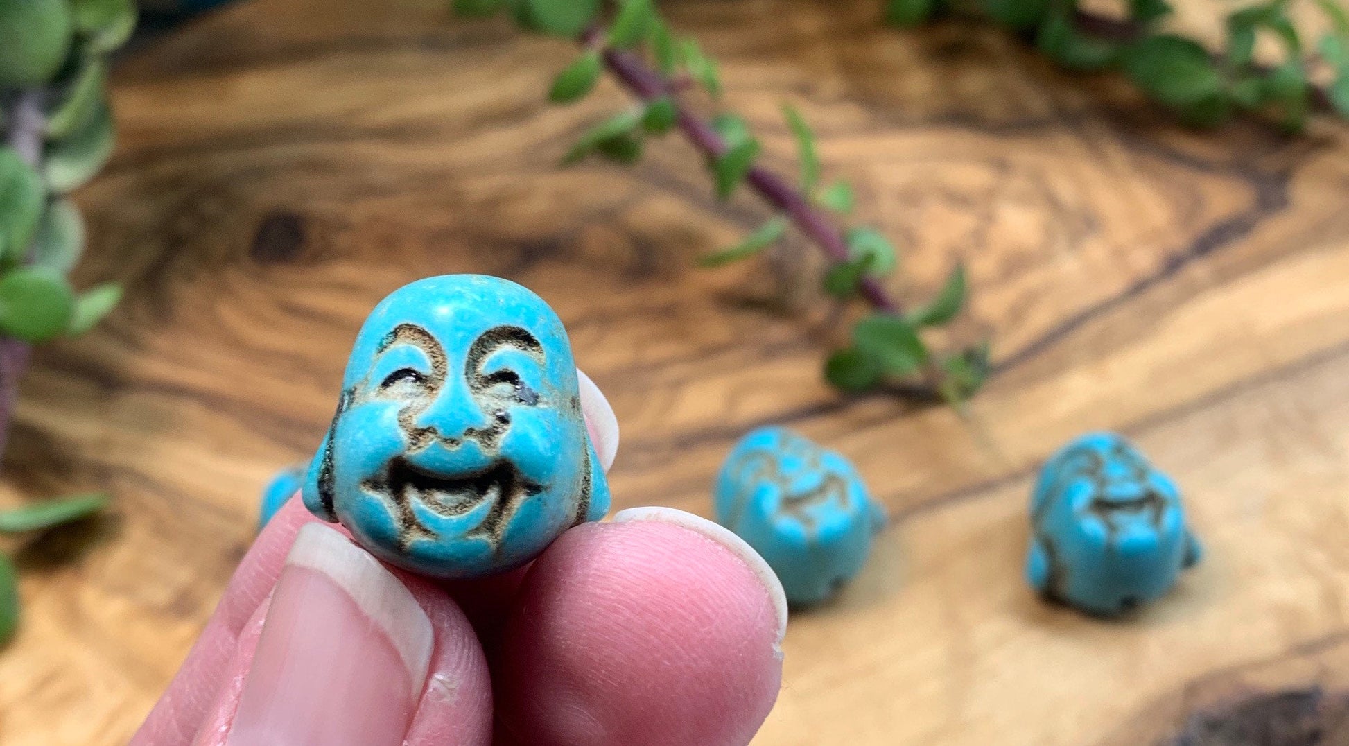 "Close-up image of a 3/4-inch blue Howlite Happy Buddha head, showcasing its intricate details and vibrant blue color.