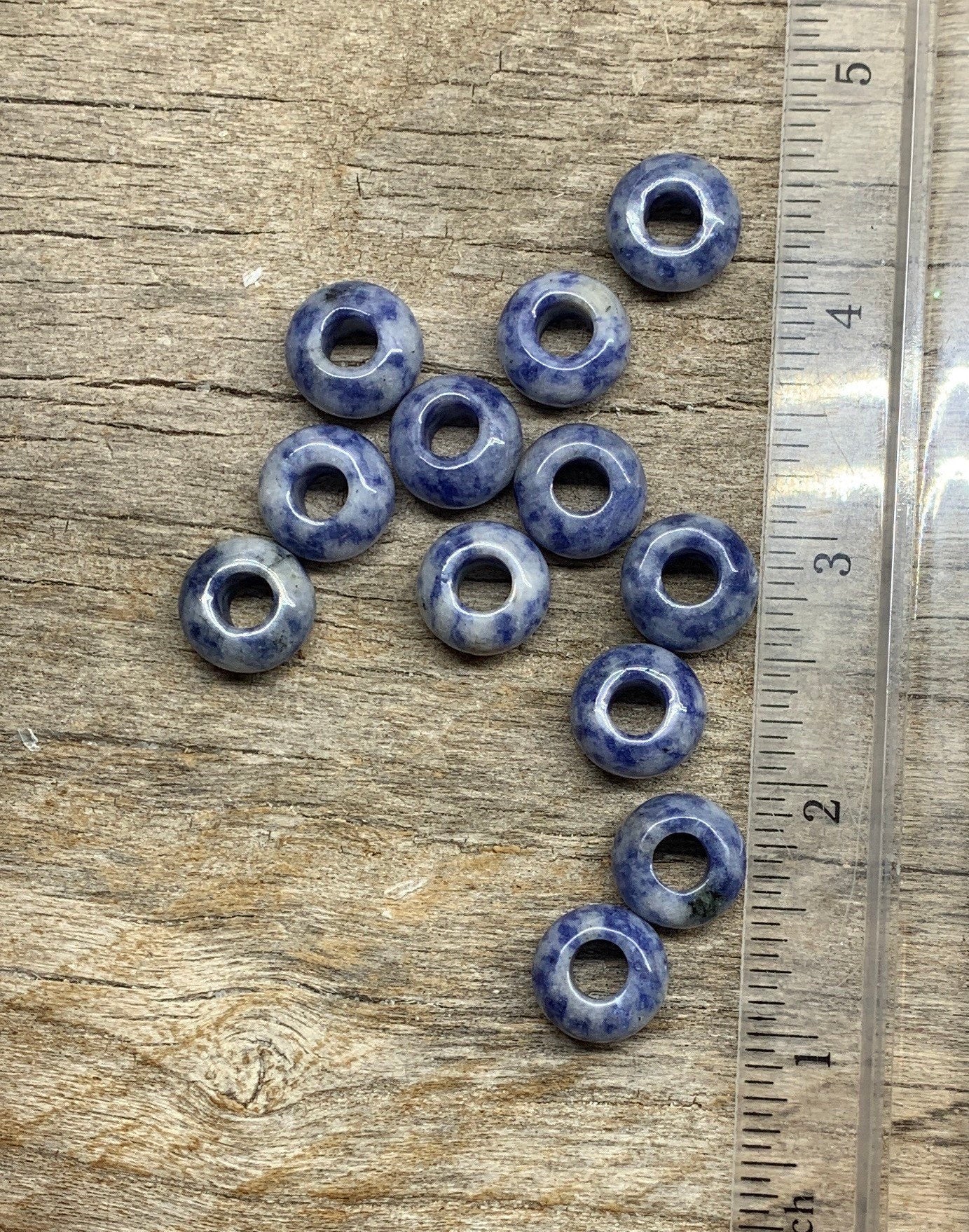 "Close-up of vibrant 14mm Sodalite beads, showcasing their rich blue hues and natural patterns, next to a ruler.