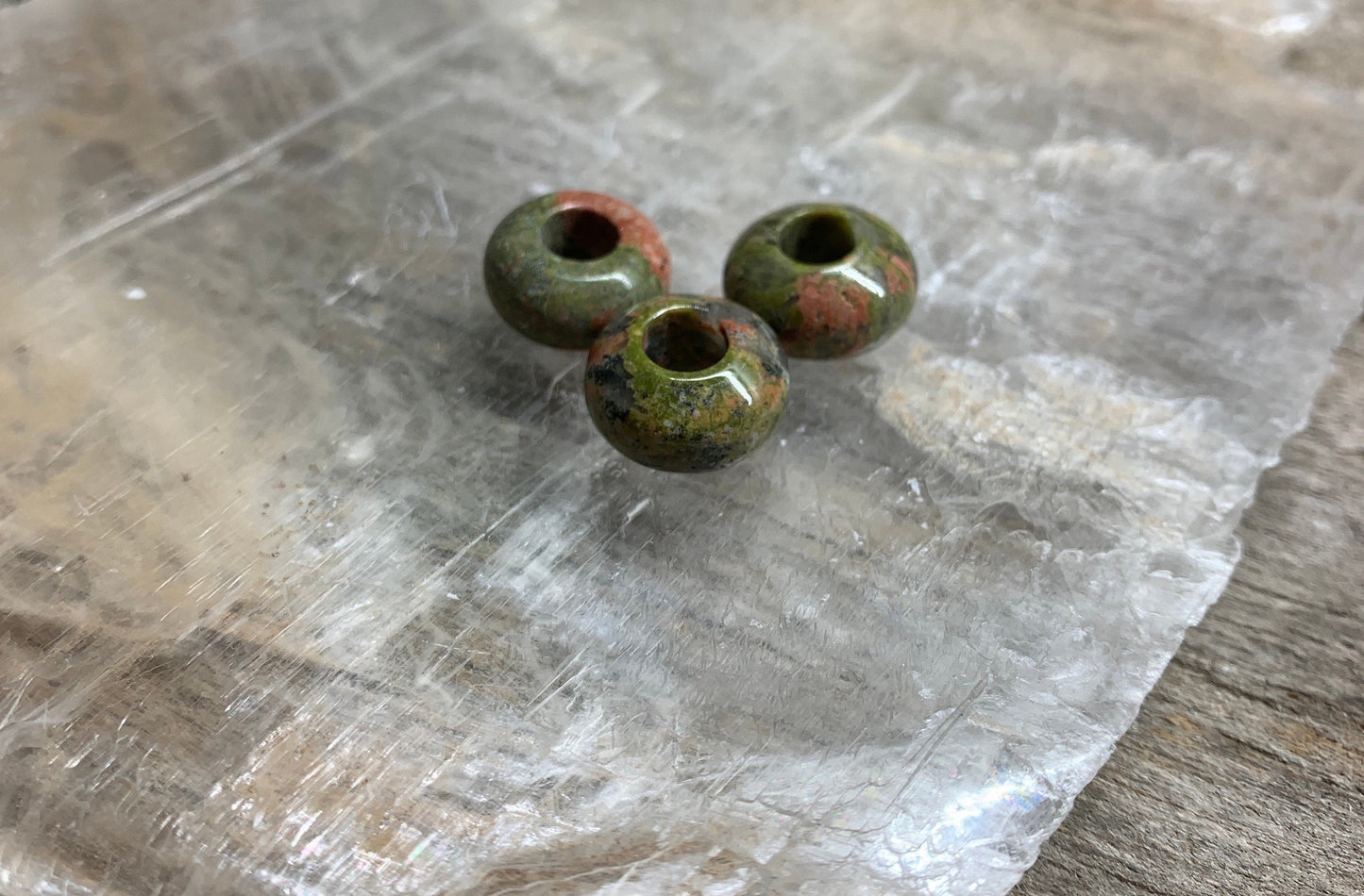 Unakite Jasper beads featuring earthy green and peach tones.