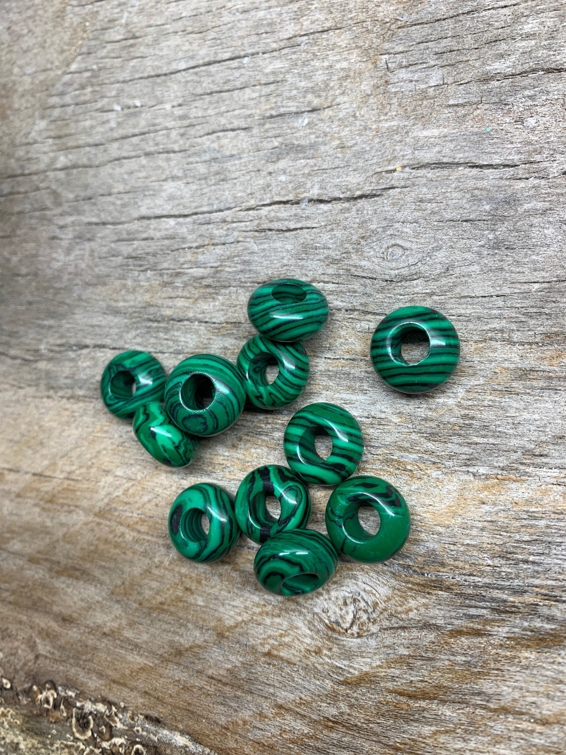 “Close-up of vibrant green malachite beads with unique striated patterns, creating an eye-catching accessory