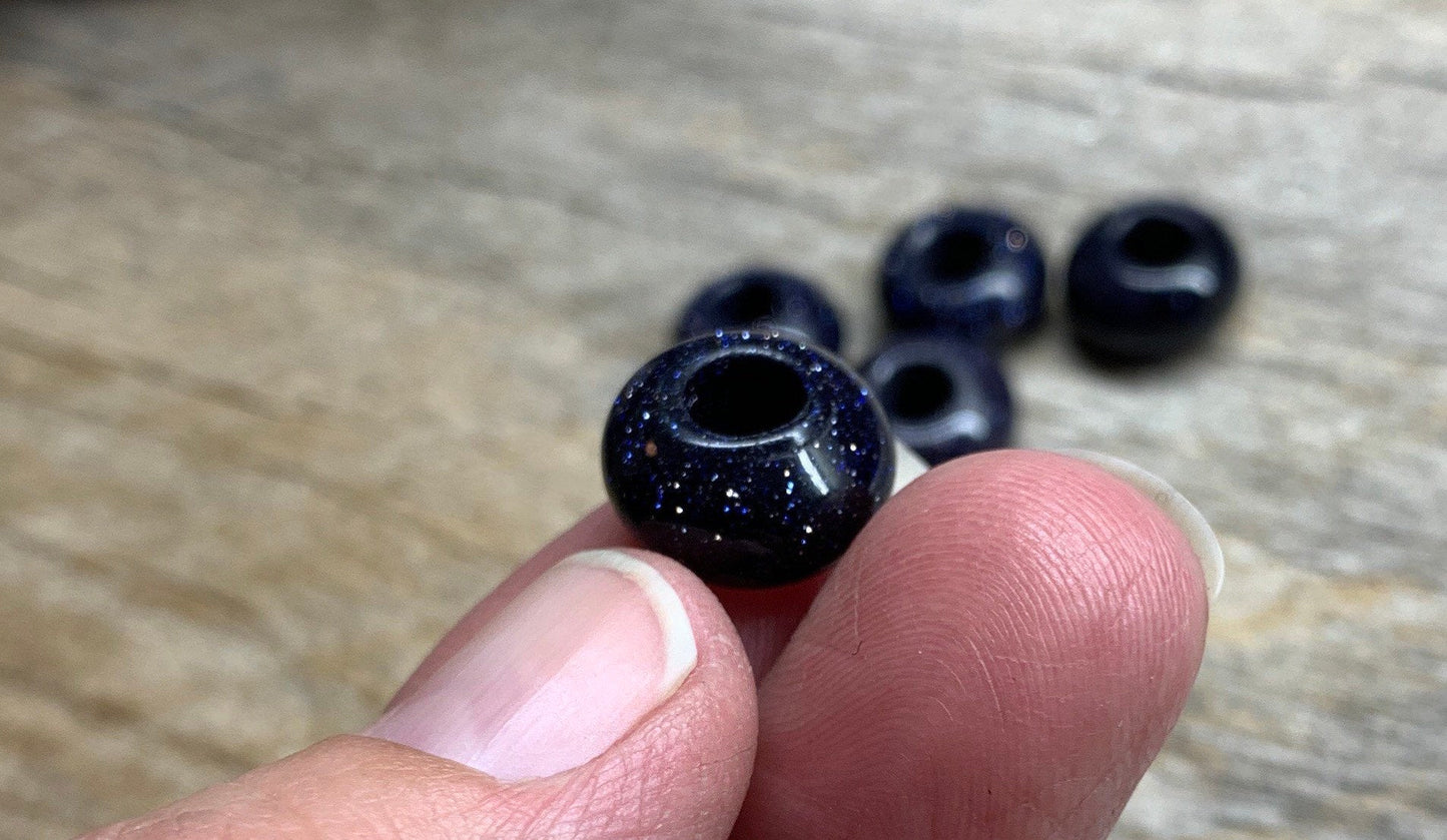  blue goldstone beads, each measuring 5mm in diameter. The beads exhibit a deep blue color with sparkling metallic flecks, creating a captivating and shimmering appearance