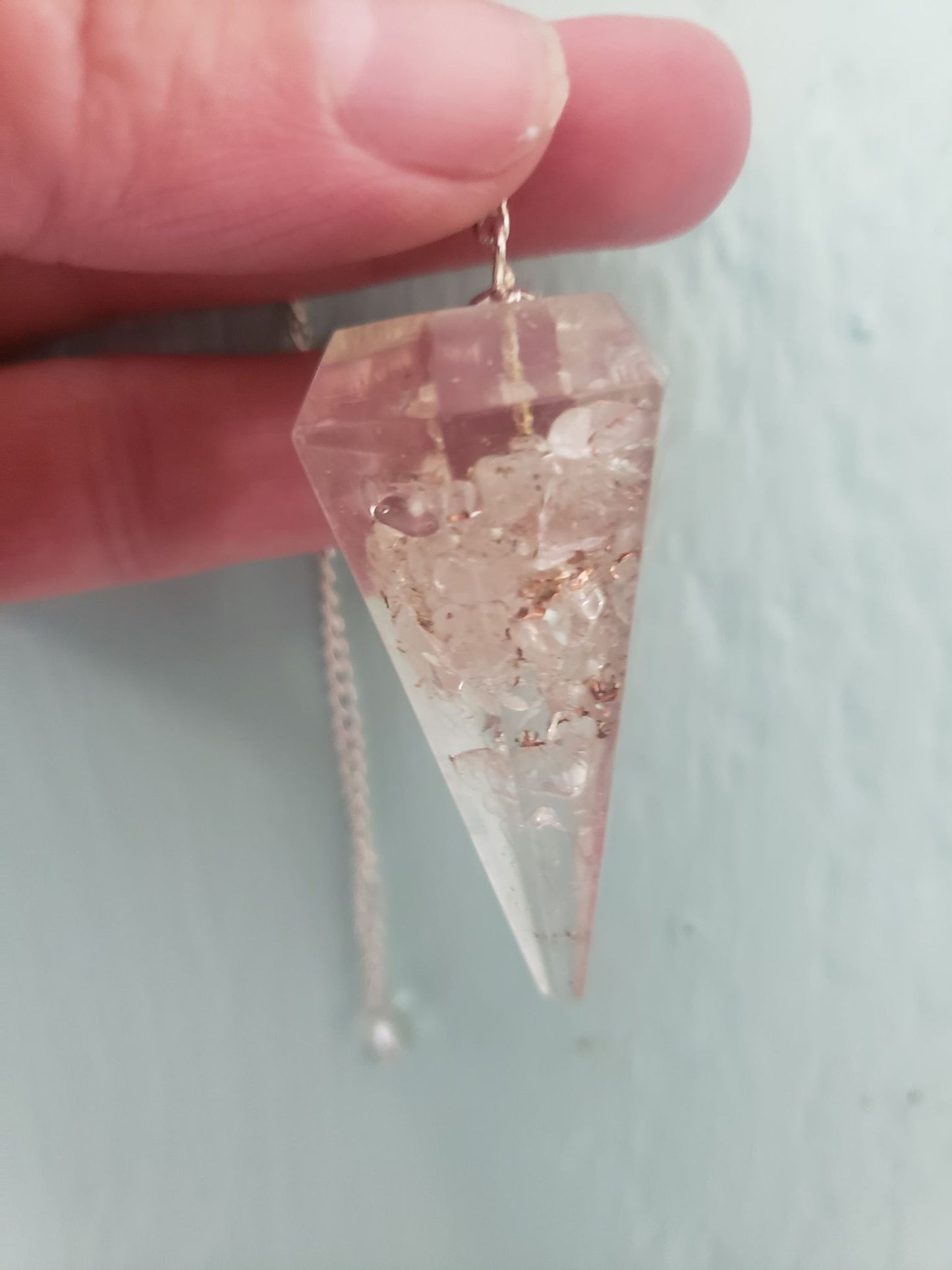 Clear Quartz 2 inch orgonite pendulum suspended from a silver 8 inch chain 