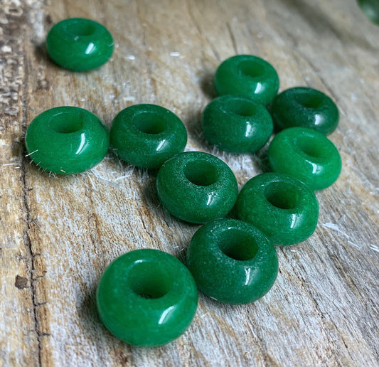 vibrant green Quartz crystal beads, reflecting light and displaying natural variations in hue and texture.