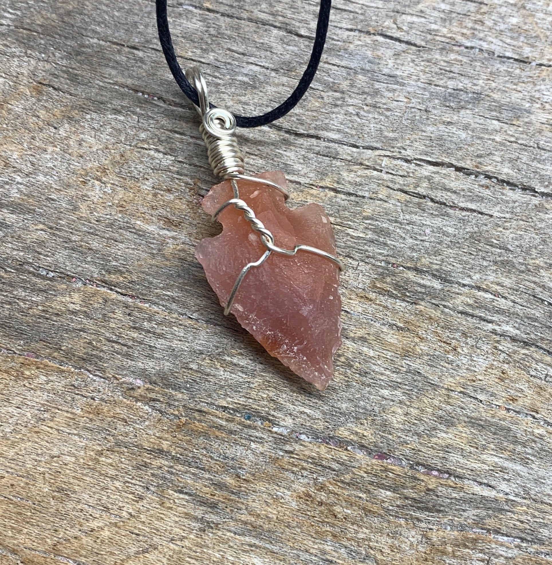 1 inch vibrant orange raw carnelian agate arrowhead, handmade, silver wire wrapped necklace, attatched to an adjistable black cord.