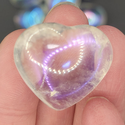 Shimmering iridescent Angel aura quartz puffy heart, approximately 1” held delicately in fingertips 