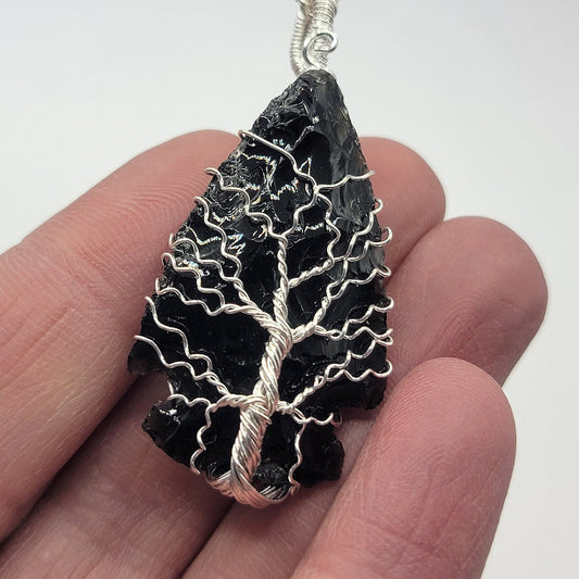 black obsidian 1 1/2 inch tree of lofe, wore wrapped, handmade, arrowhead pendant attarxhed to a silver necklace