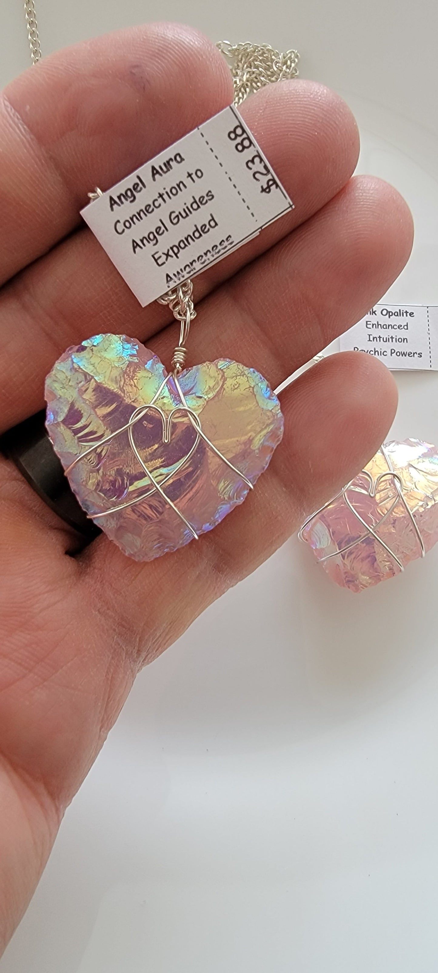 shimmery amd metallic looking  angel aura pink opalite knapped heart, silver wire wrapped pendant attatched to a silver chain