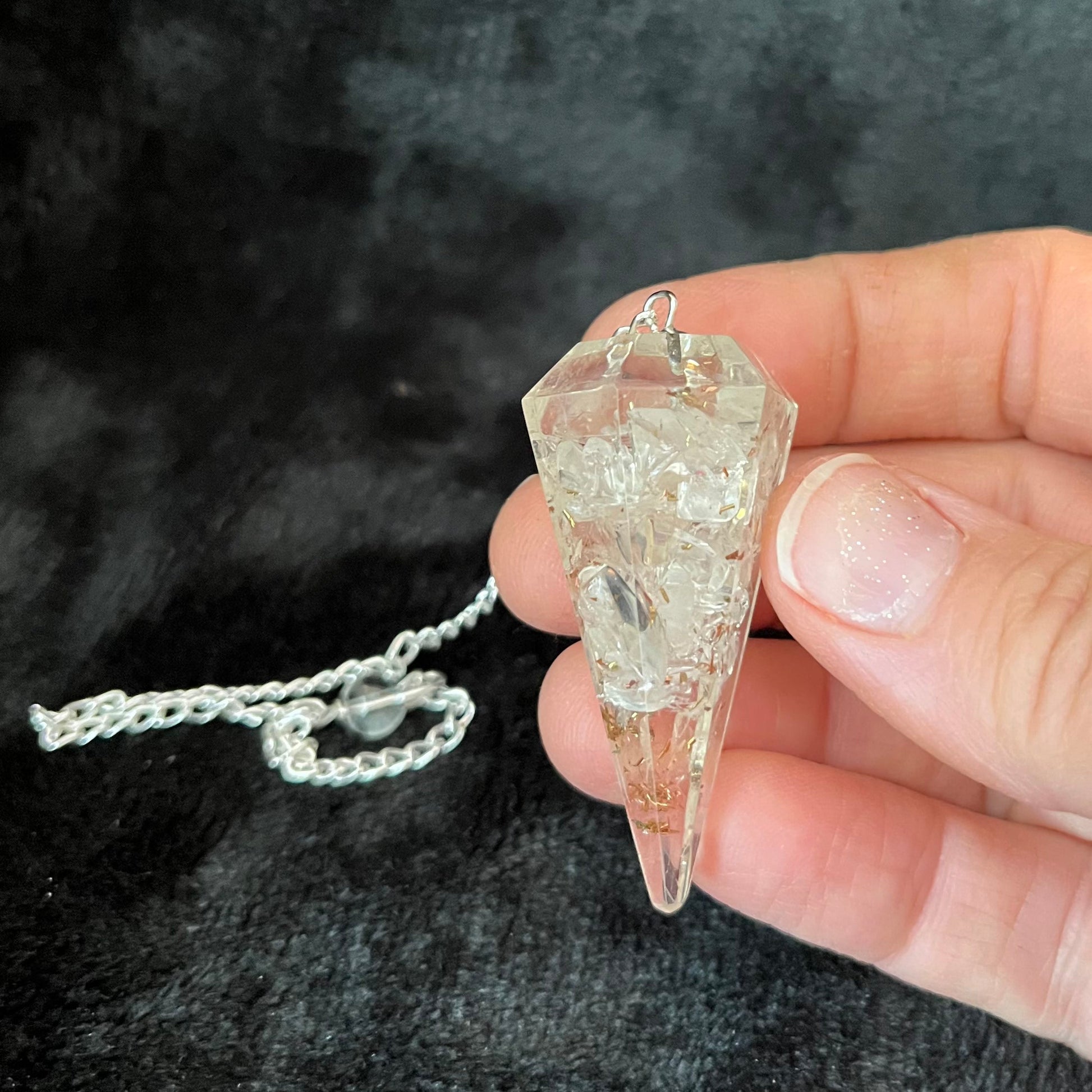 2 inch clear quartz crystal point orgonite pendulum attatched to a silver 8 inch chain.