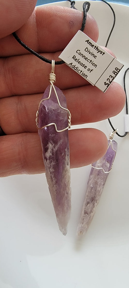 dragon tooth amethyst crystal silver wire wrapped pendant, approximately 2 inches long, attarched to an adjustable black cord.  