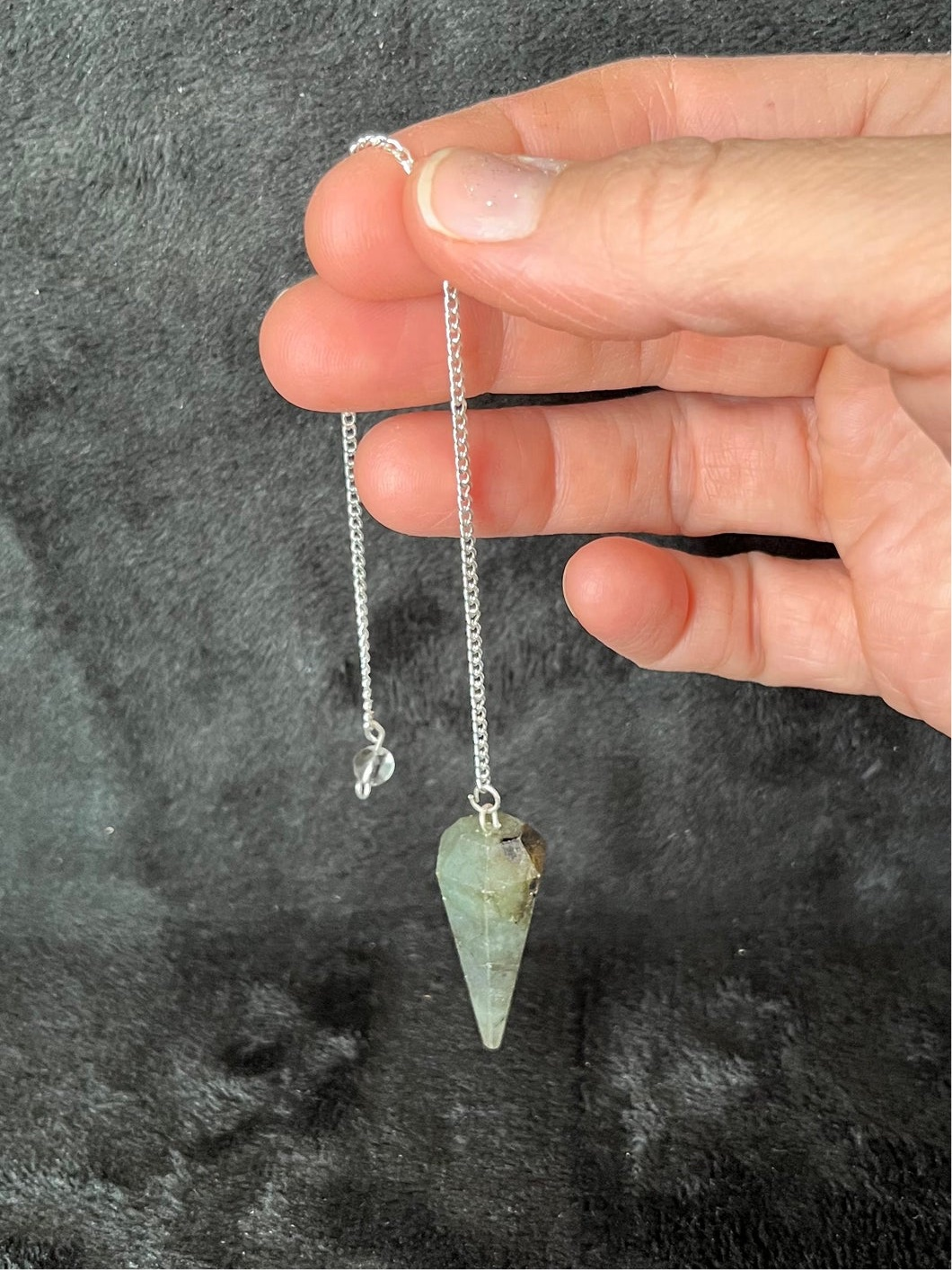 1 1/2 inch Labradorite crystal point pendulum attatched to an 8 inch silve chain.