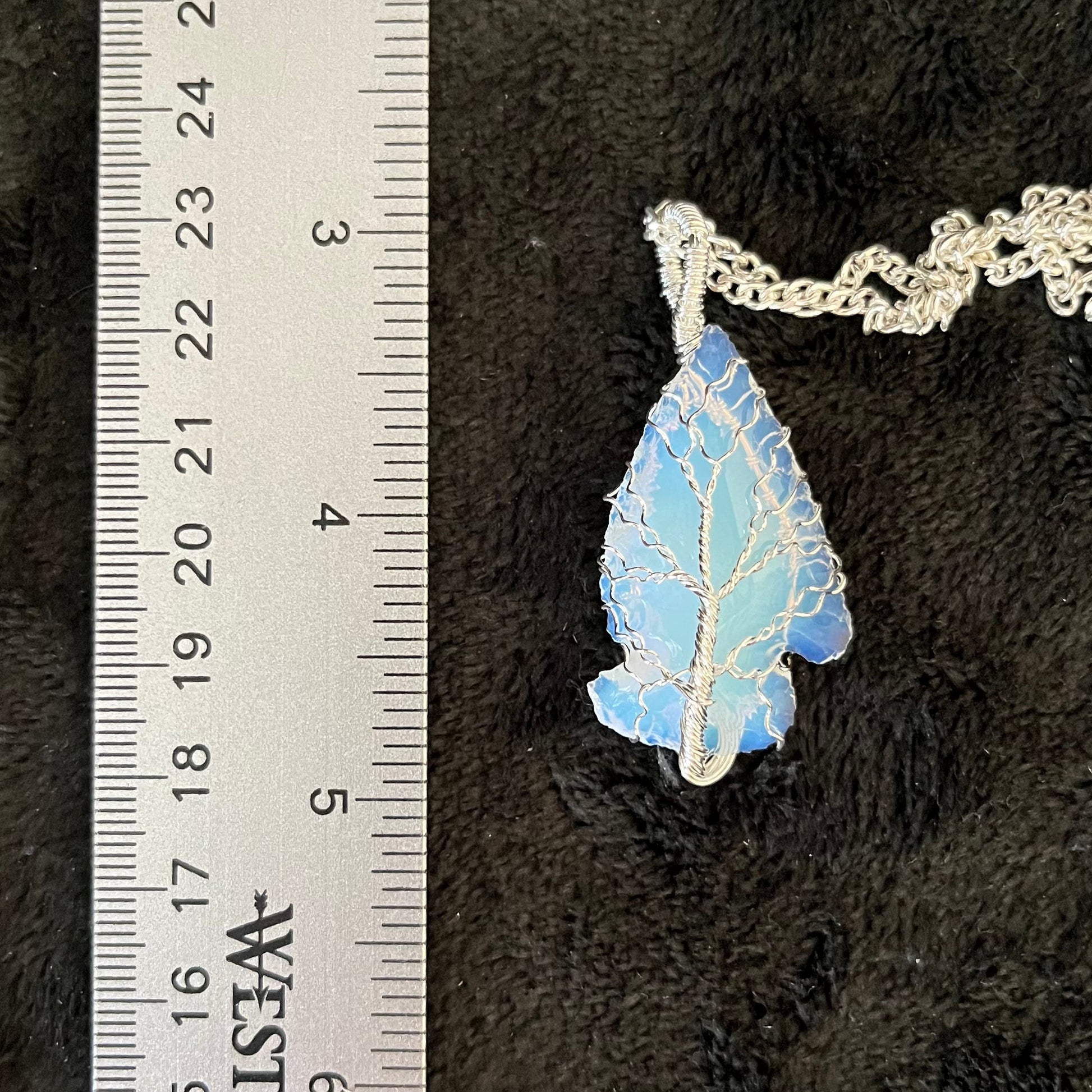 beautiful tree of life, silver wire wrapped opalite arrowhead pendant with a silver chain.  displayed next to a ruler. Opalite arrowhead crystal is approximately 1 1/2" long