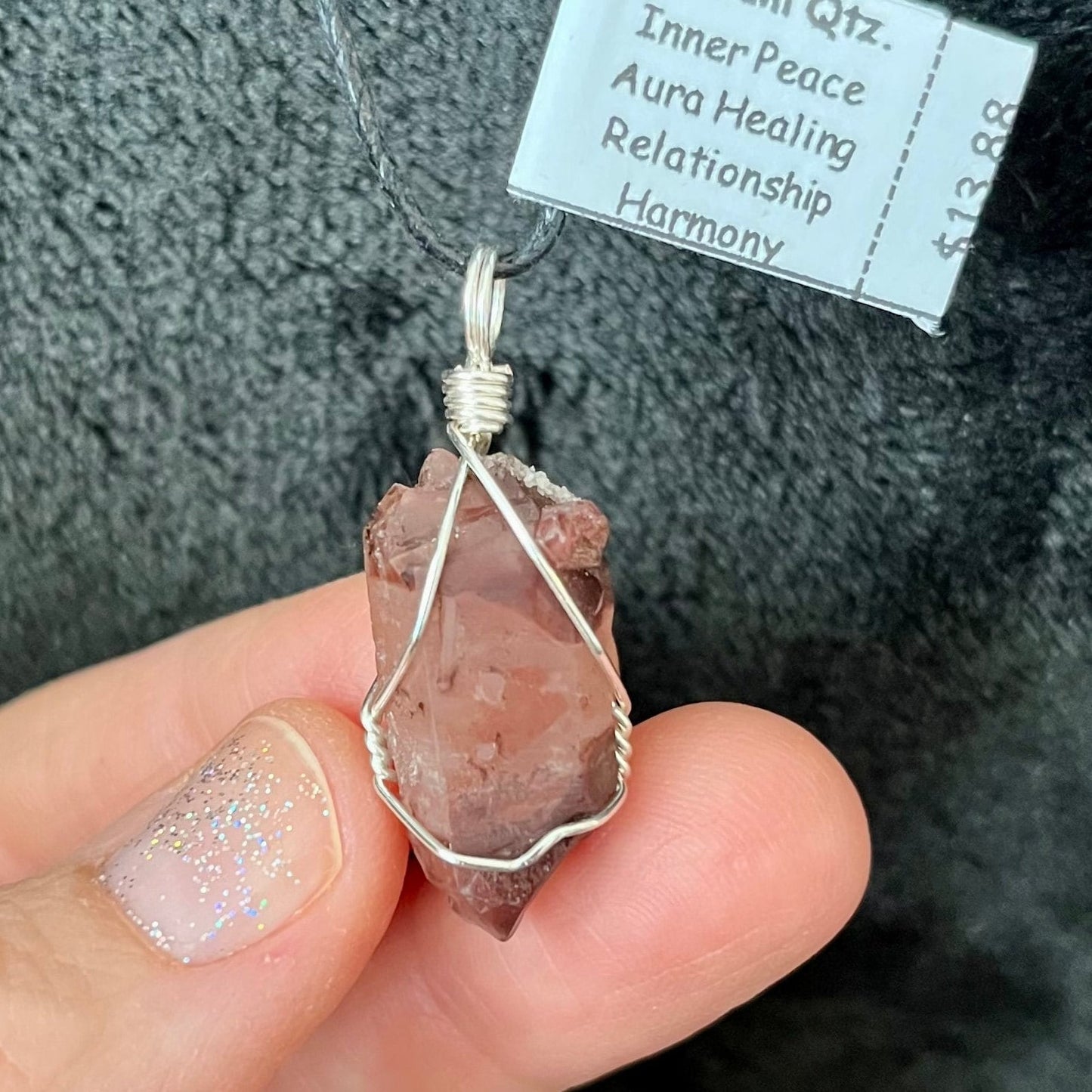 silver wire wrapped lithium quartz point pendant, with an adjustable black cord.  quartz crystal is apprximately 1" long.