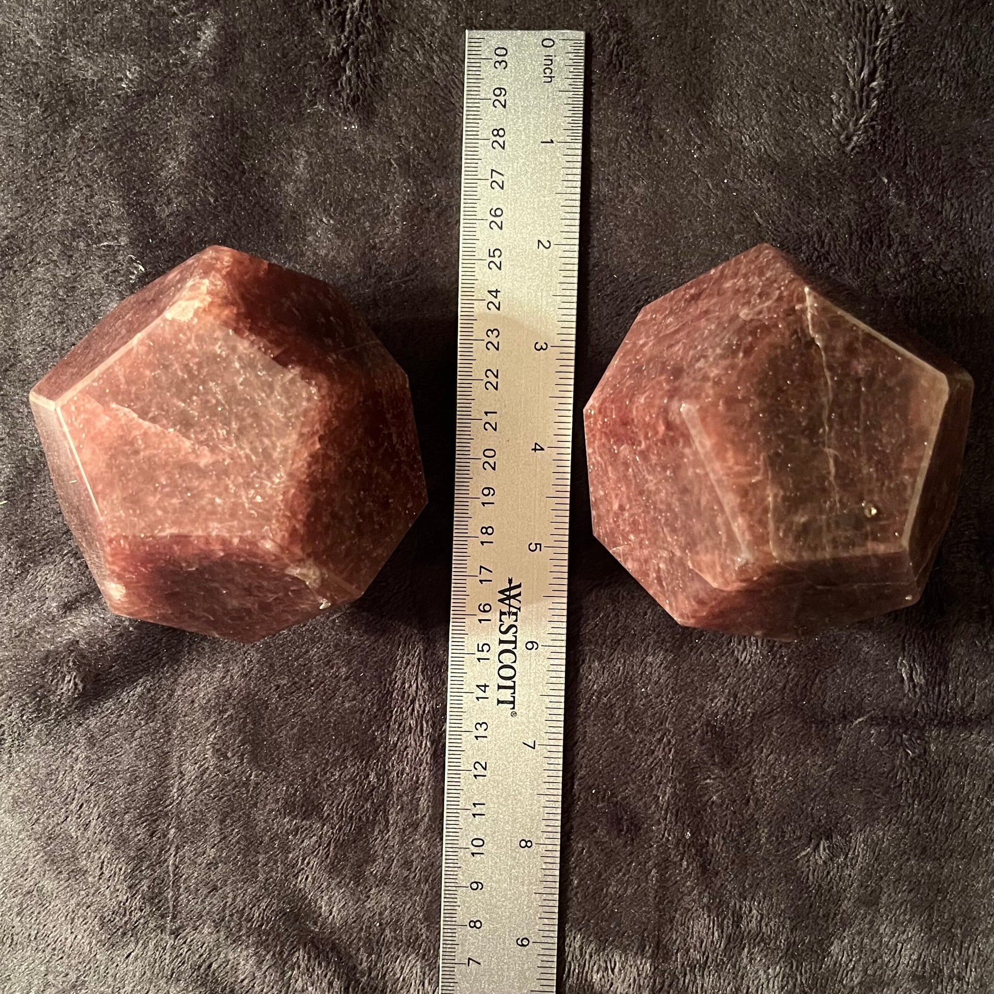 Two large beautiful translucent, pink strawberry quartz dodecahedrons display next to a ruler to show size. They are approximately 85 mm in diameter.