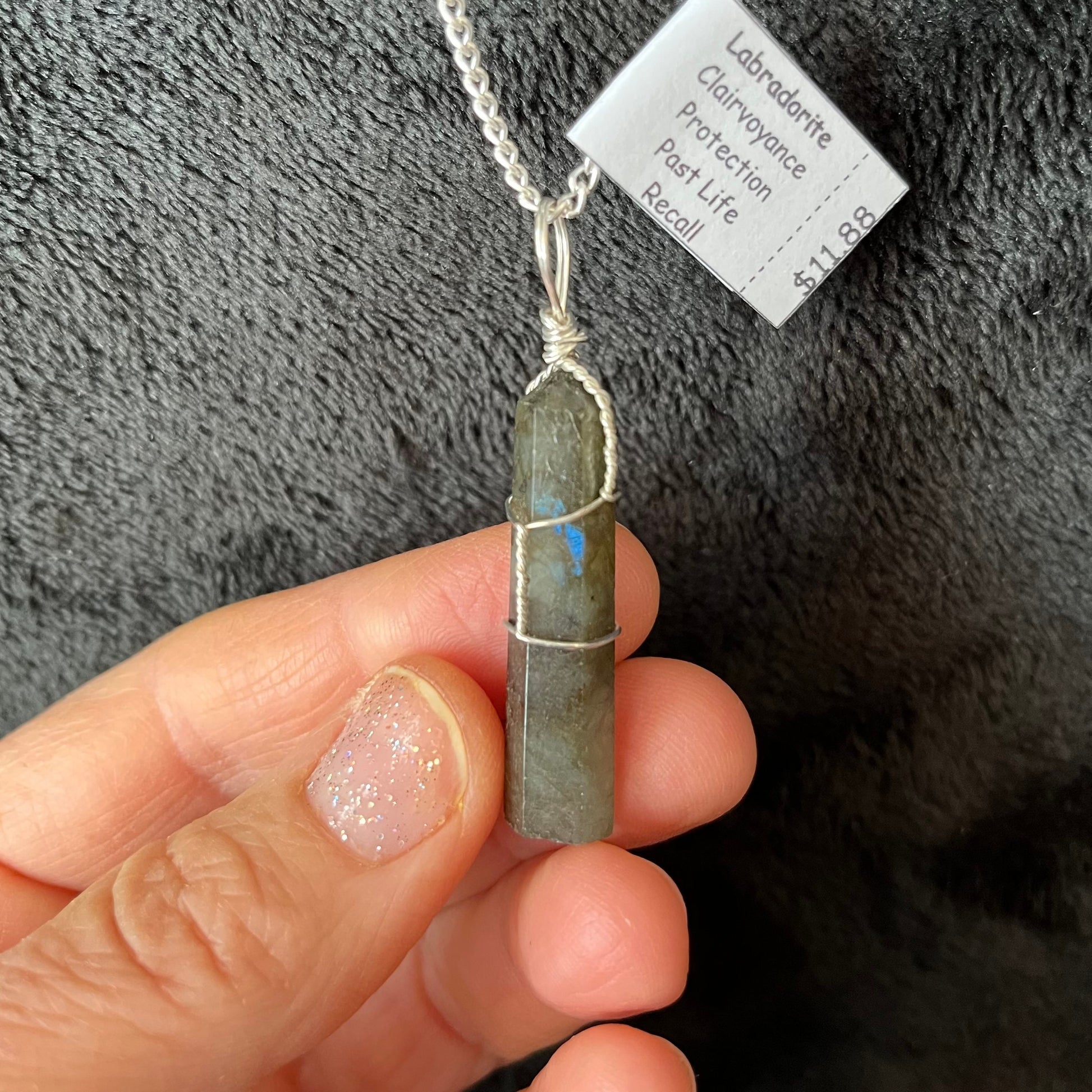 Silver Wire Wrapped Labradorite Point Pendant attatched to a silver chain.  stone is approximately 3/4" long