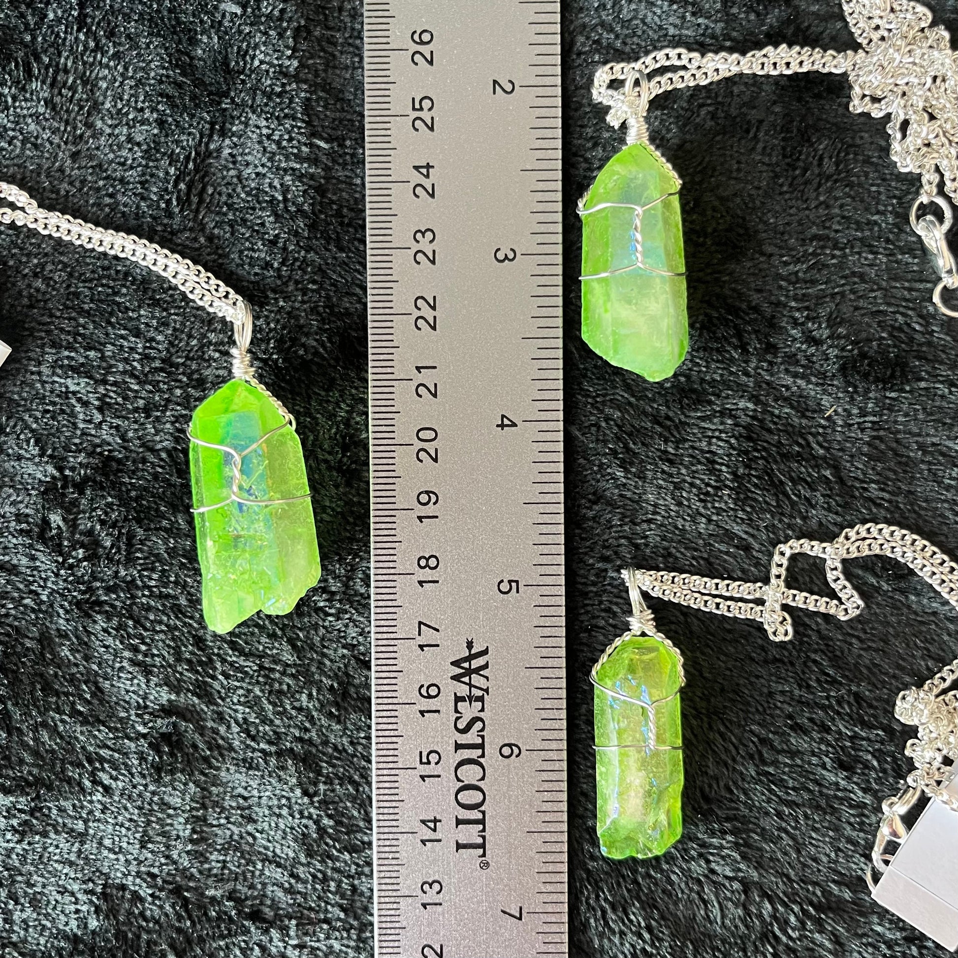 3 silver wire wrapped green aura quartz pendants on silver chains, displayed next to a ruler.  quaetz crystals are 1 1/4" to 1 1/2" long.