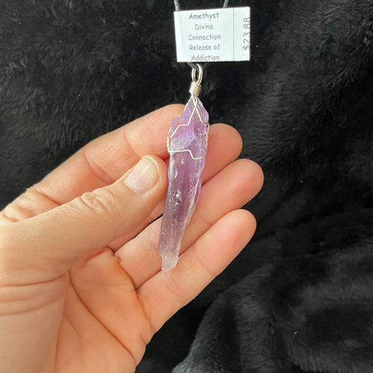 dragon tooth amethyst crystal silver wire wrapped pendant, approximately 2 inches long, attarched to an adjustable black cord.  